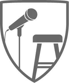 Microphone and stool inside a shield.